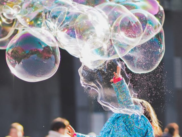 girl playing with bubbles