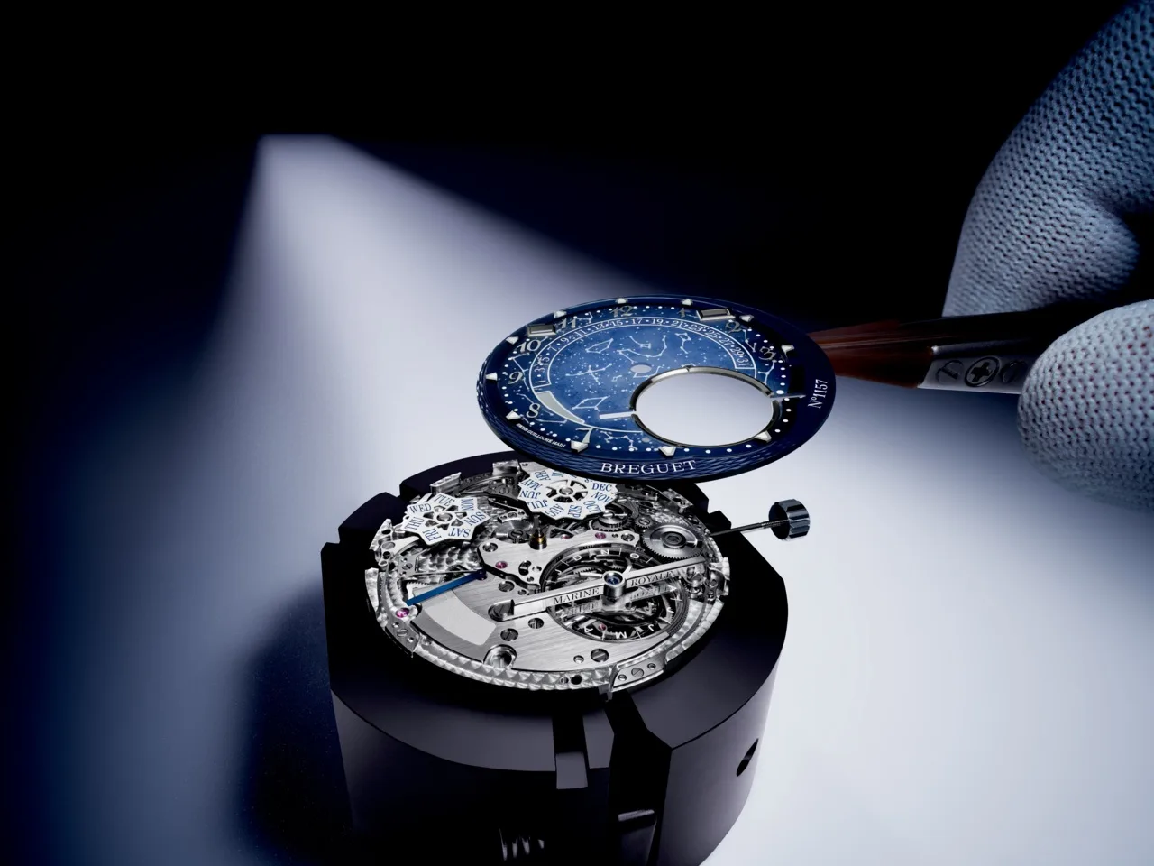 Fixing the grand feu enamel dial, executed in Bleu de France, with the depiction of the Paris night sky on June 26, 1801, to the Breguet Marine 5887.
