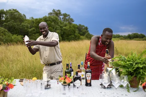 Seringet Mara staff prepare cocktails in the open grasslands of the Maasai Mara