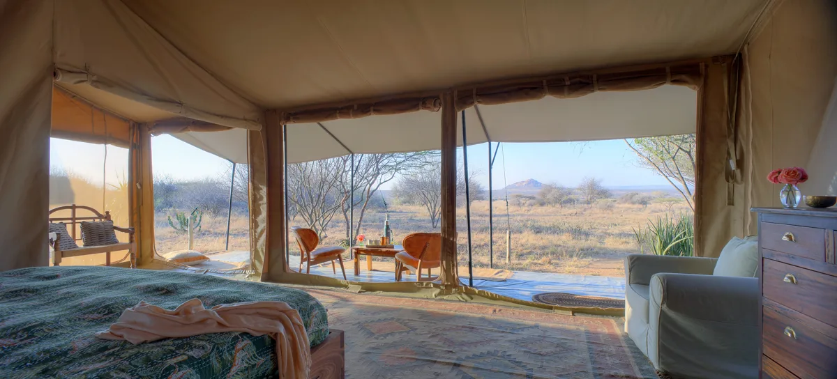 Luxury tent at Tumaren Camp, with views of the watering hole