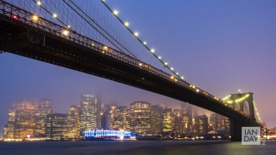 Evening mist rolls in over Manhattan and Brooklyn Bridge, New York, USA.