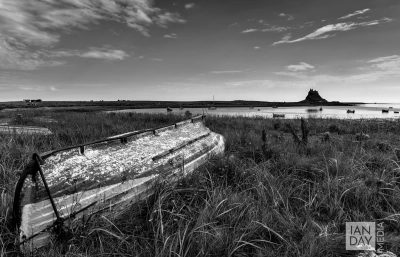 Old fishing boats lie upturned on the Holy Island of Lindisfarne.