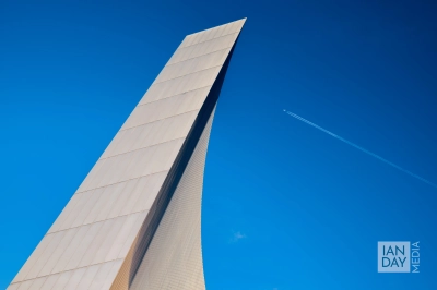 An airplane flies high over the Imperial War Museum North in Manchester.