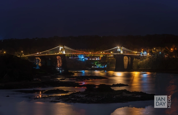 The Menai Suspension Bridge spans the Menai Strait between the island of Anglesey and the mainland of Wales.