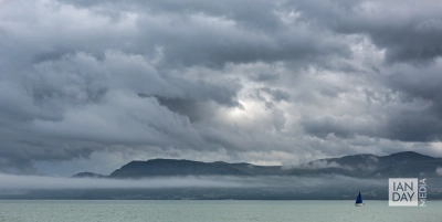 A small sailing boat heads to harbour as heavy storm clouds push in over the Menai Strait in North Wales.