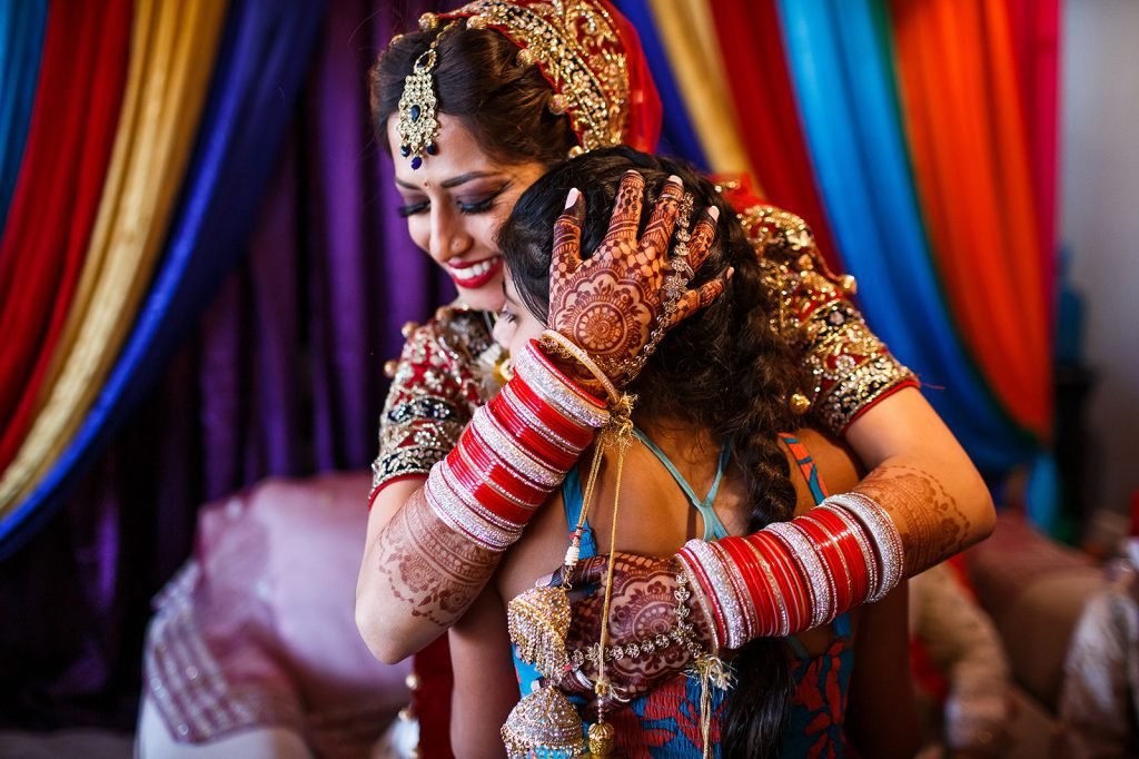 Bride hugging her siter