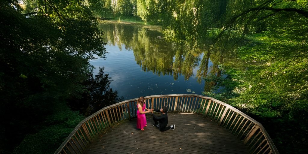 Couple by serene lake, romantic moment.