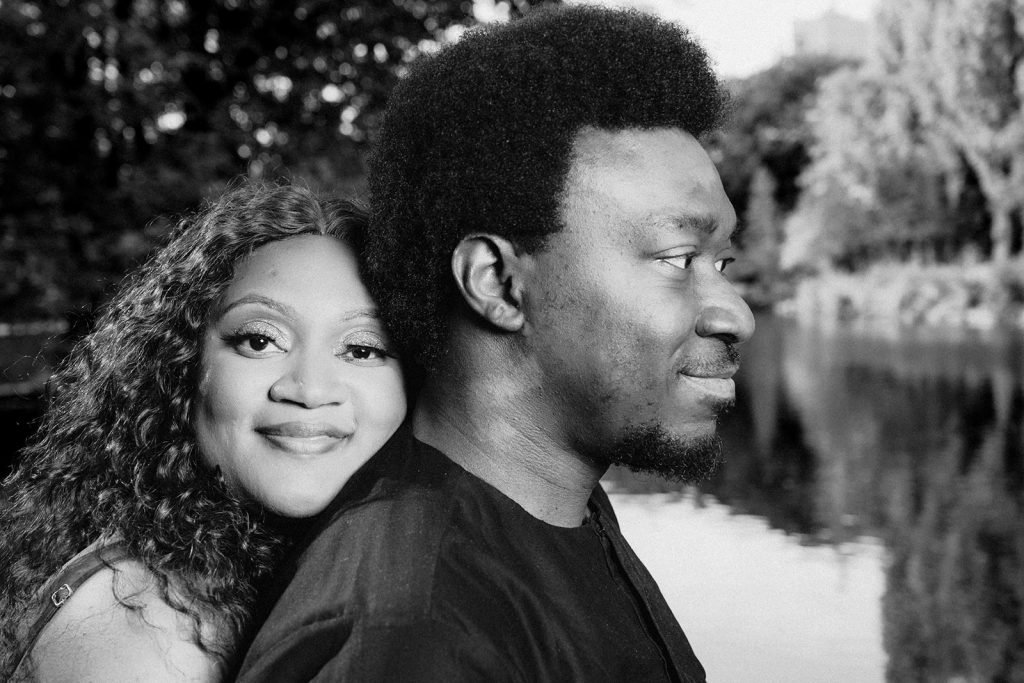 Couple by serene water at sunset.