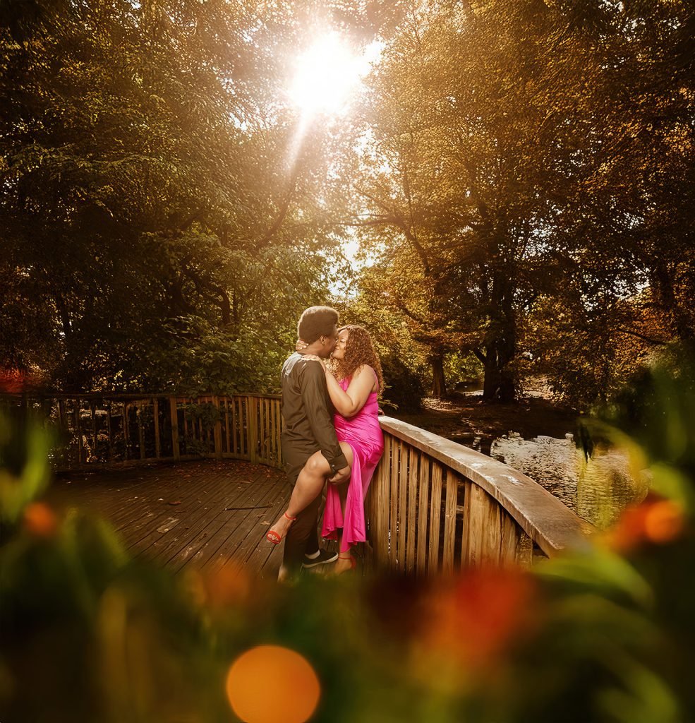 Couple embracing in autumnal park setting.
