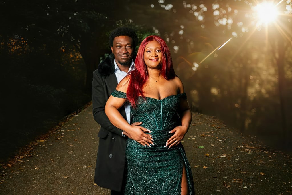 Couple embracing in a forest setting.