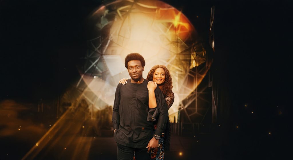 Couple embracing against a glowing backdrop.