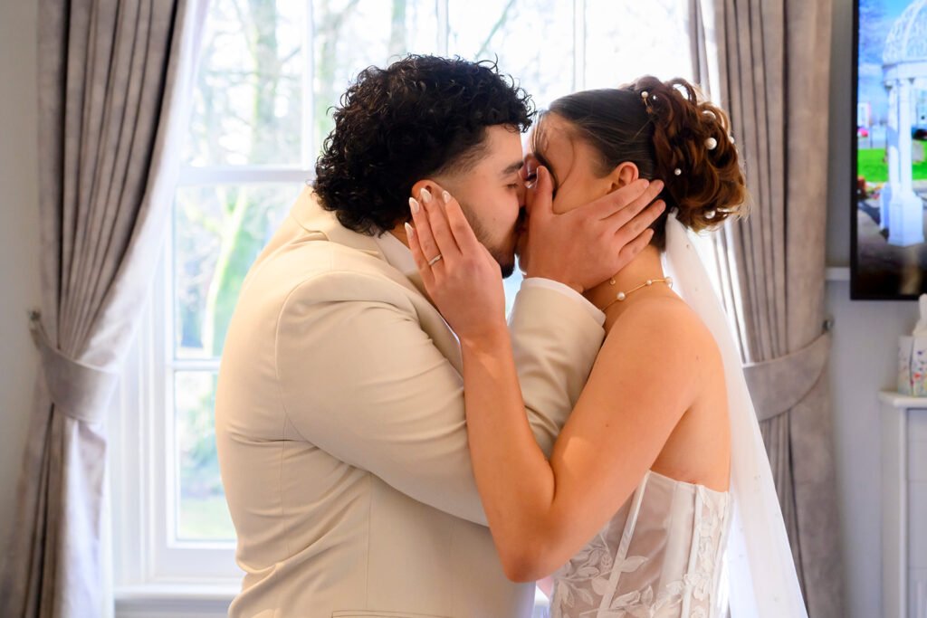 Newlyweds first kiss at Sandwell Register Office wedding ceremony.