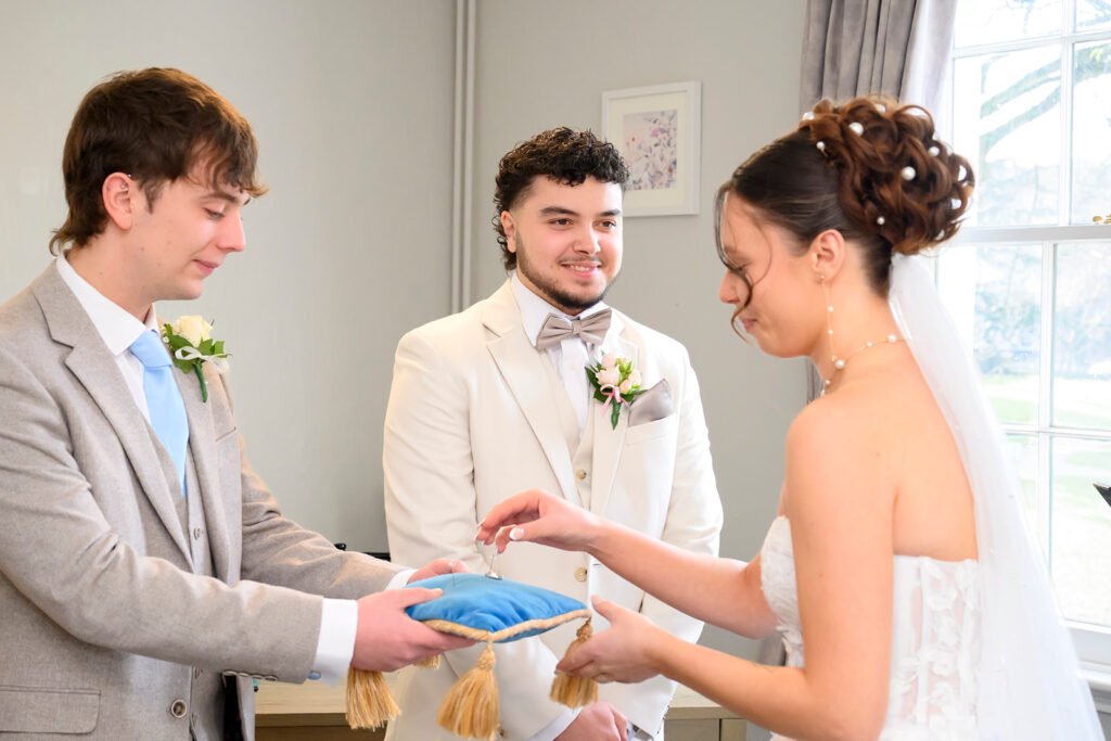 Groom adjusting his suit for West Midlands wedding.