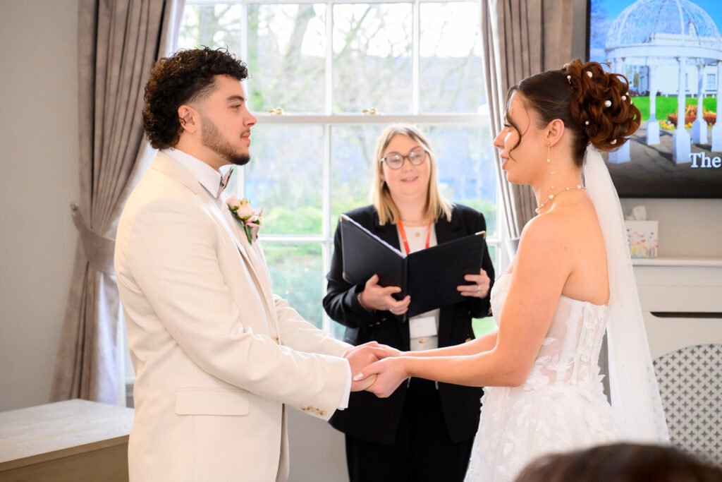 Couple listening to the registrar during Sandwell wedding ceremony.