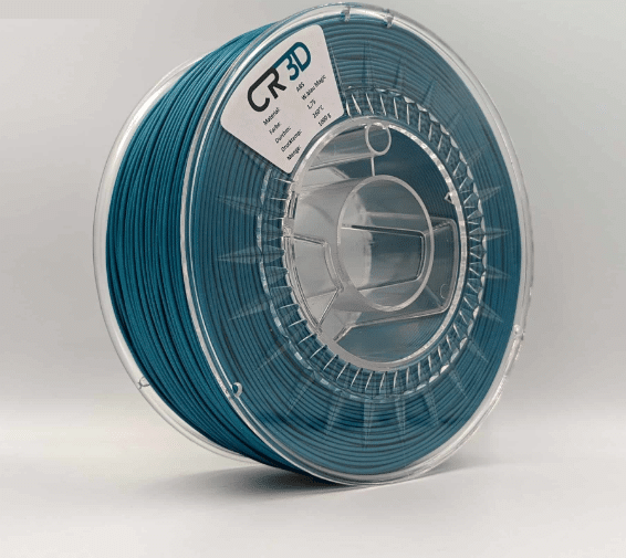 Aufnahme einer Spule von der Seite mit wasserblauem magic 3D-Druck-Filament der Marke CR3D, beschriftet mit Angaben zu Material (ABS), Farbe (Wasserblau Magic), Durchmesser (1,75 mm), Drucktemperatur (260 °C) und Menge (1000 g).