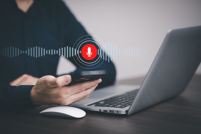 Businessman using laptop and touch microphone button on virtual screen. Blog blog speak talk advertising presentation,Voice recognition, speech detection and deep learning application,Voice Assistance