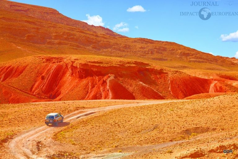 Off-road car driving on a desertic landscape. Dades Valley, Morocco.