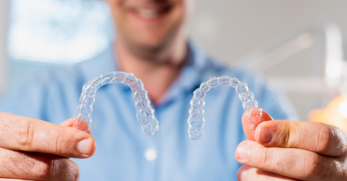 Dentist with Invisalign braces