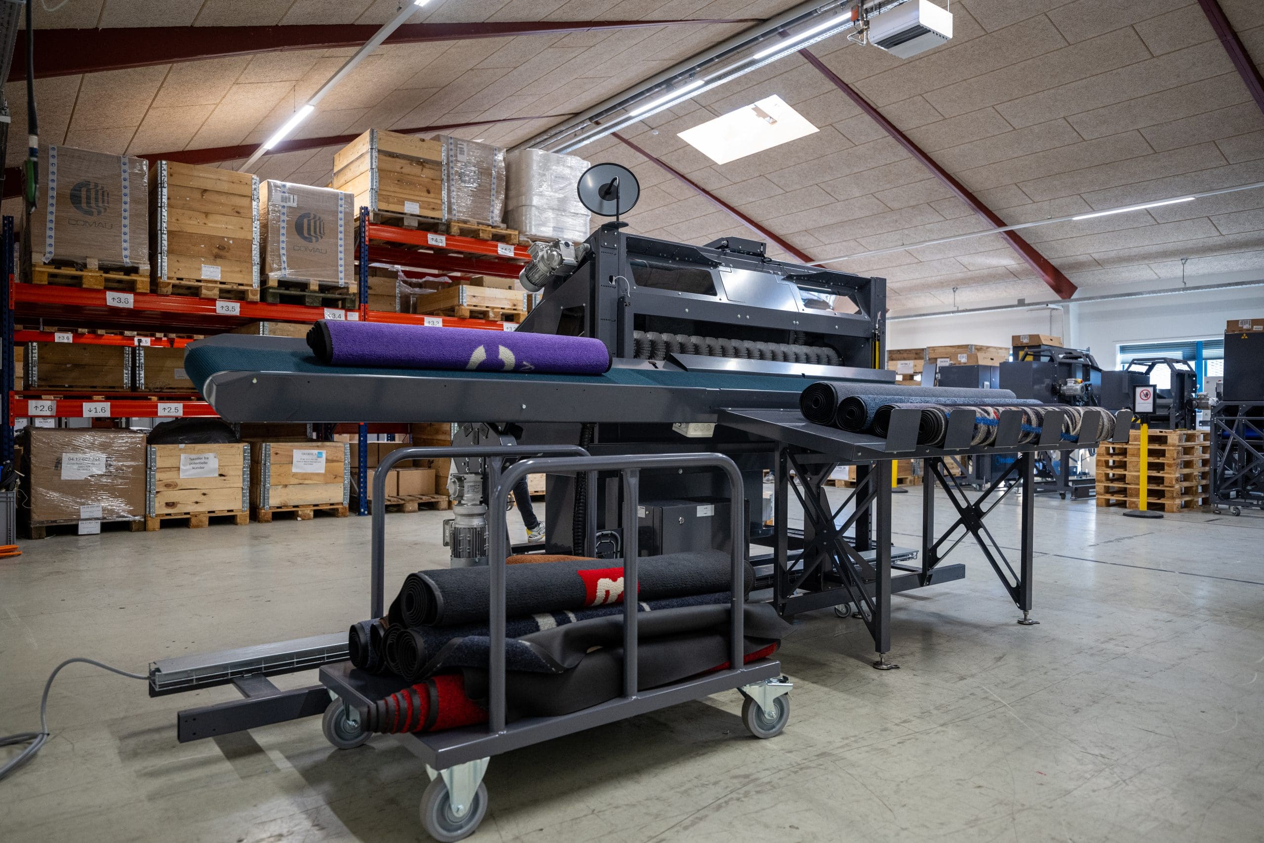 Close-up showing how the Inwatec Typhoon Mat Roller machine is rolling the mats and sending them out nicely rolled up.