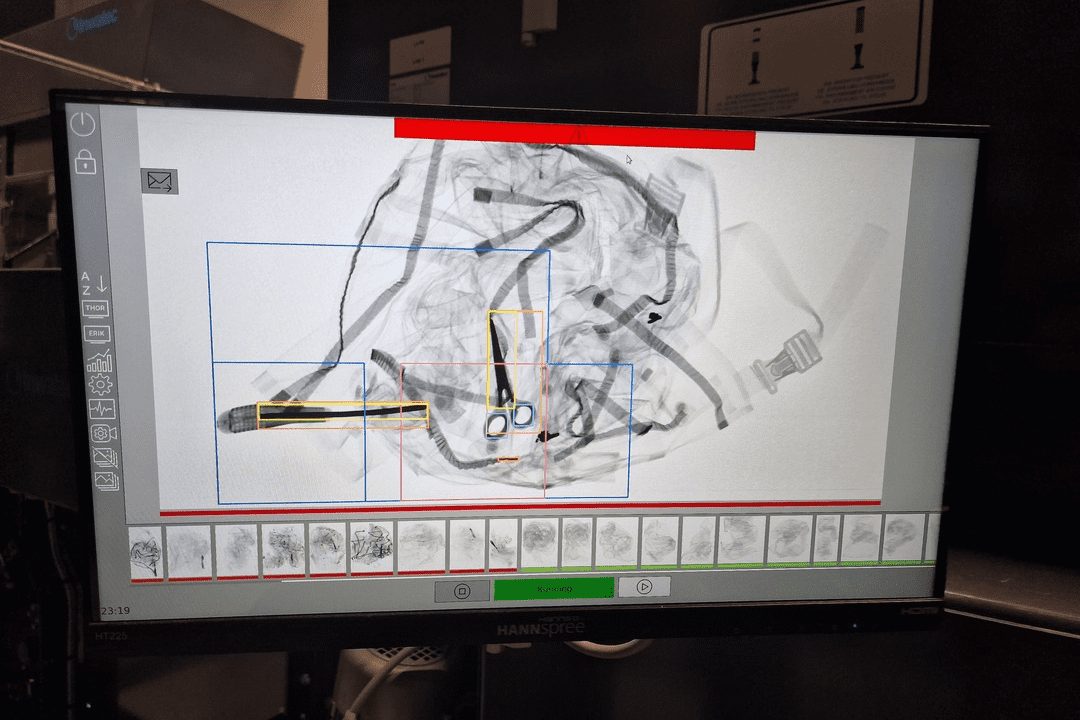 Wide-screen showing how the Inwatec Odin XRay machine is checking for content such as scissors and other materials.