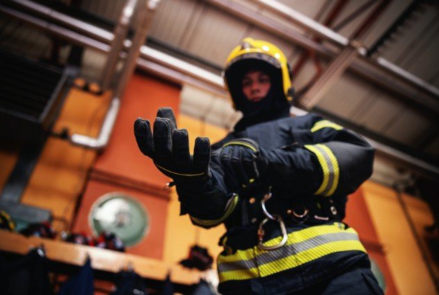 Firefighter putting on his glove.