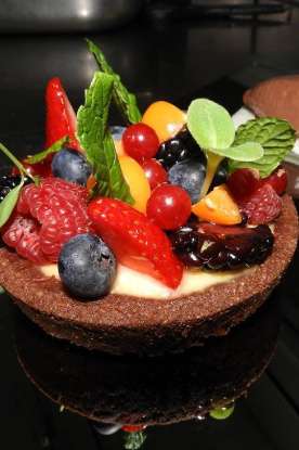 Chocolate tart with passion creme fresh forest fruits and Ferrero ice cream