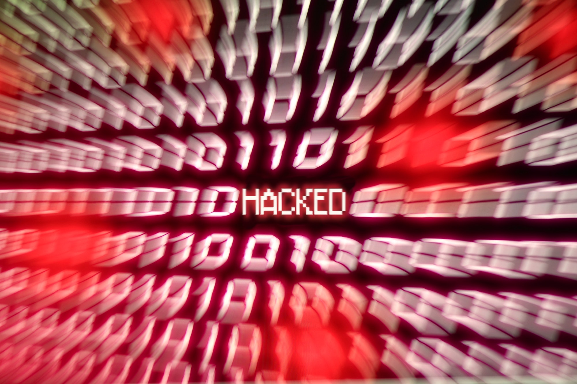 HACKED Computer binary number stream blurred. Concept for hacker cyber attack danger