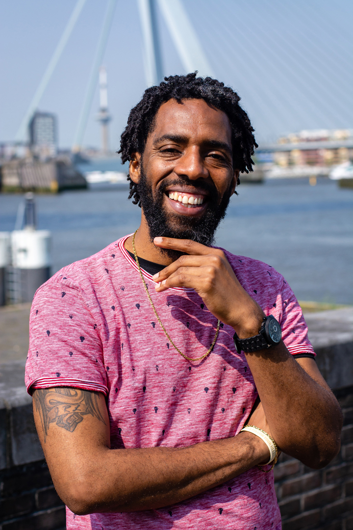 This is a photograph of Josuël Rogers life coach laughing in front of Erasmus Bridge
