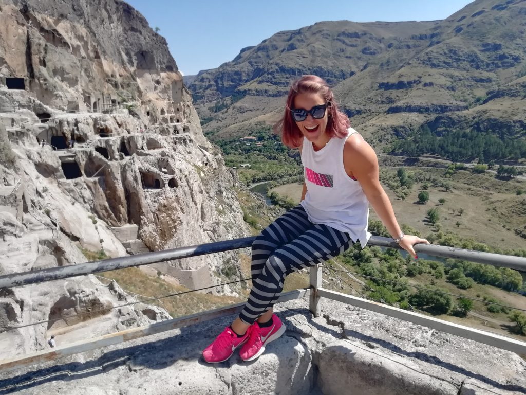 woman sitting on railing laughing