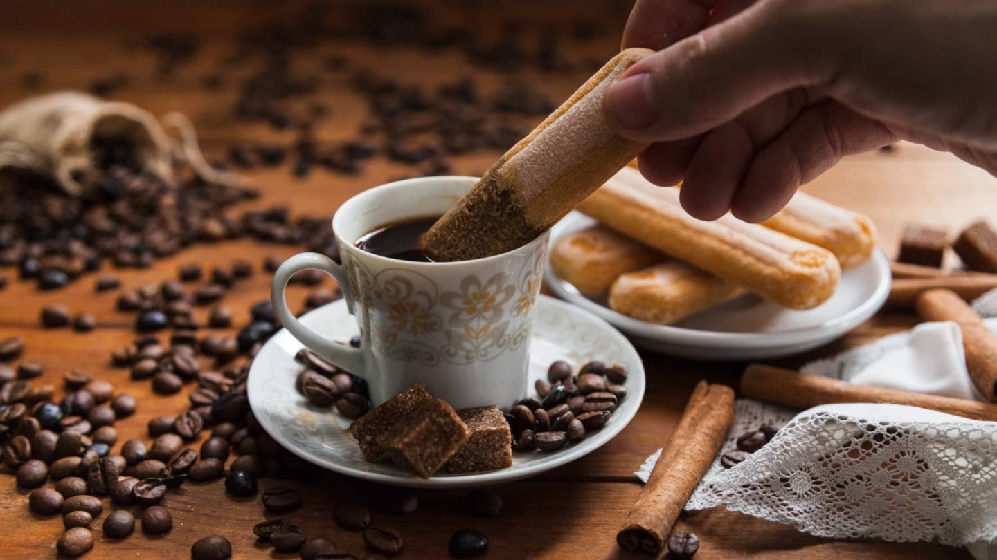crop-hand-dipping-cookie-into-coffee (1)