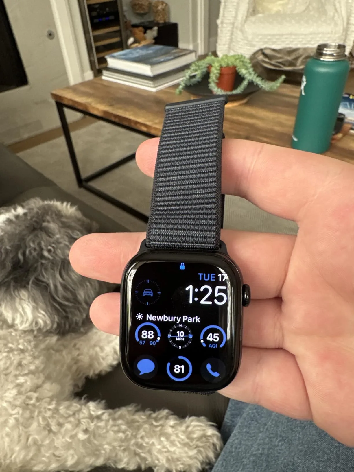 a hand holding a smart watch