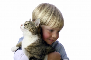 Young boy with pet cat in arm