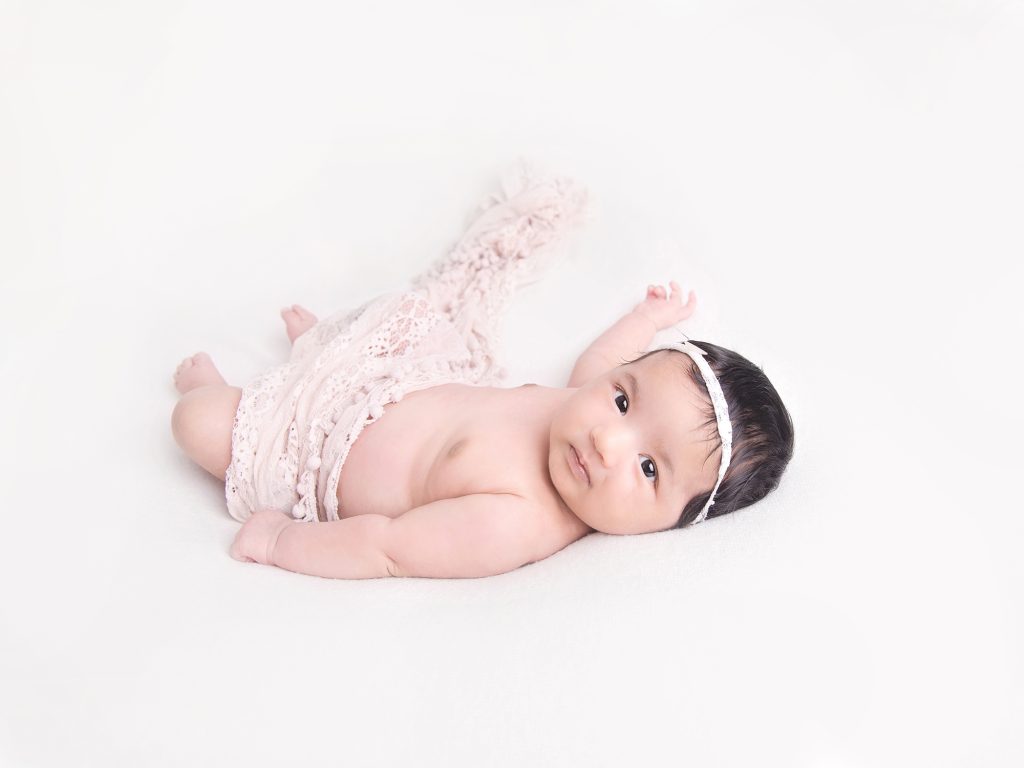 older newborn posing 10 weeks old girl with pink wrap and headband, eyes open newborn photography edinburgh