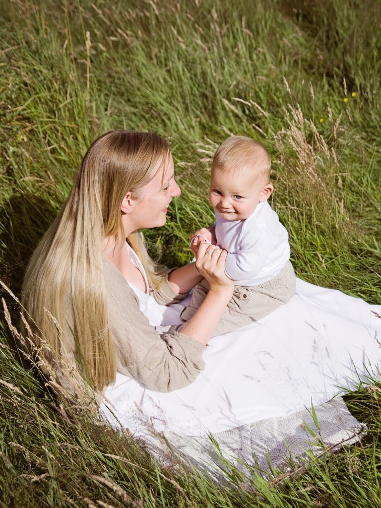 mum and baby in the field golden hour posing family photography edinburgh