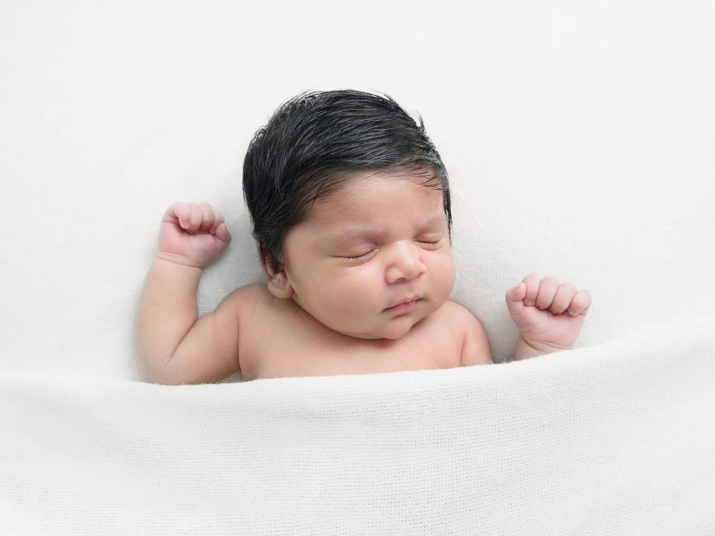 dark hair newborn baby on the back with blanket over him, newborn photographer edinburgh