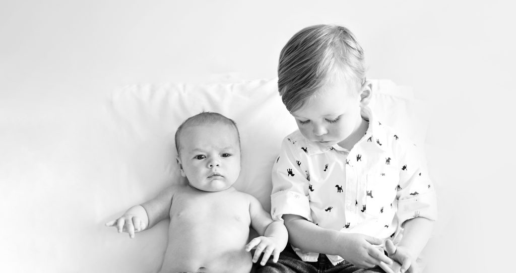 toddler with baby sibling reading a book - family photography edinburgh