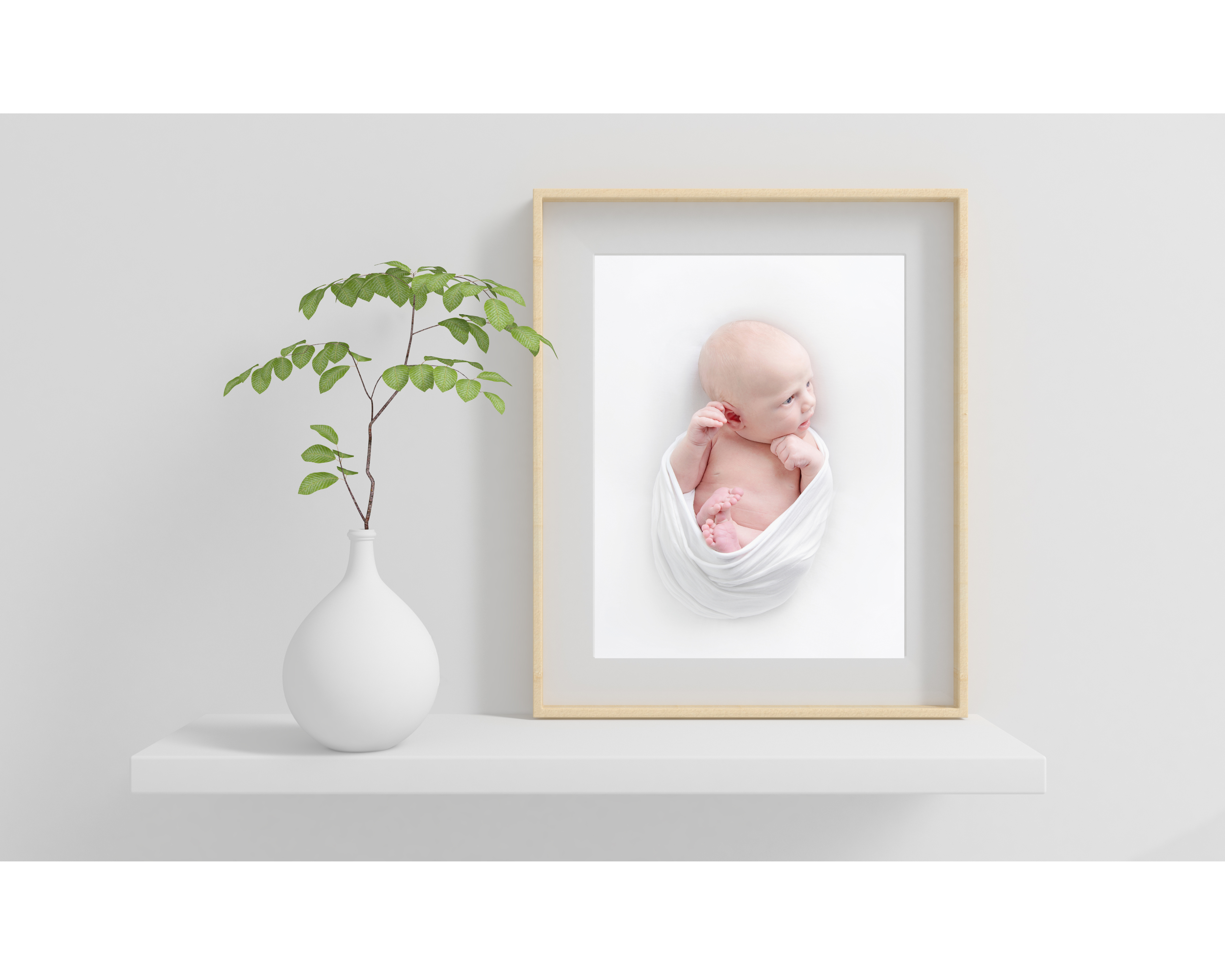 framed newborn portrait on a white shelf - newborn photography edinburgh