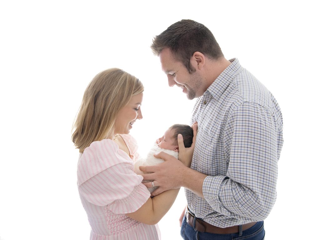 backlit parents with newborn photos