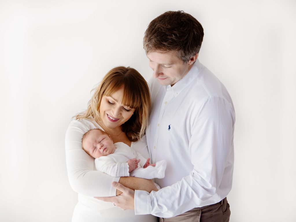 all white studio family with newborn photography poses