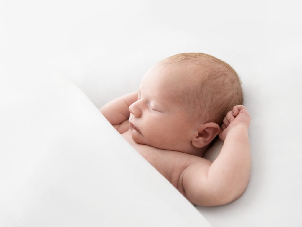 tucked in pose all white newborn photography