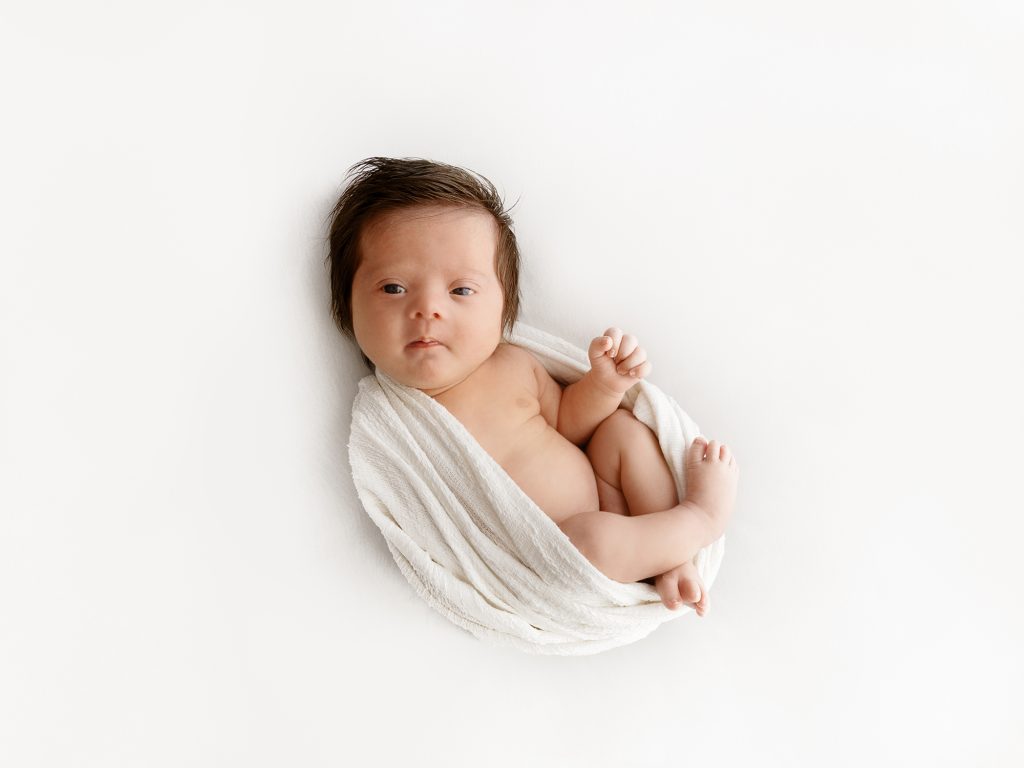 newborn baby on his back 1 month old photoshoot