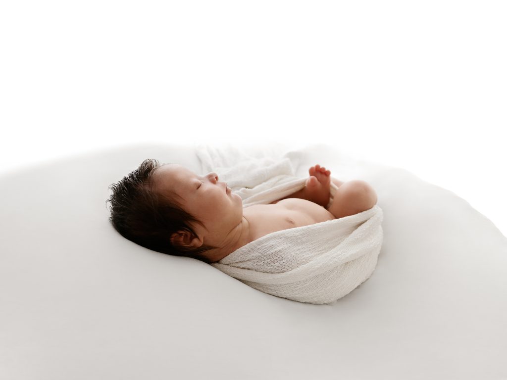 back lit baby on his back photos
