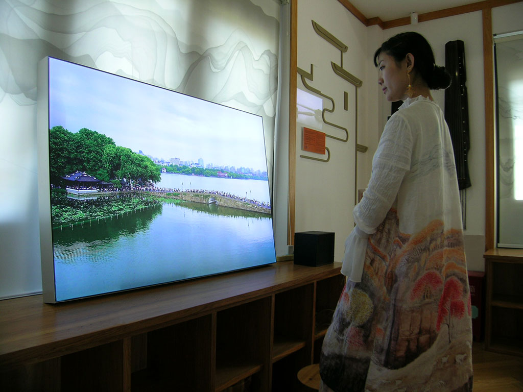 Visitor viewing light-box installation from Empathetic Walking Panel at Heritage Museum, China, 2020
