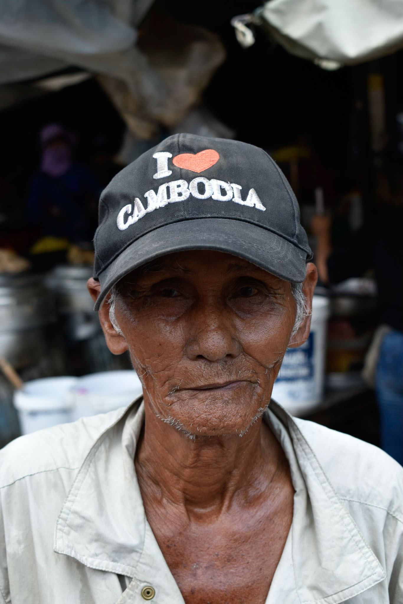 rickshaws driver with I love Cambodia cap