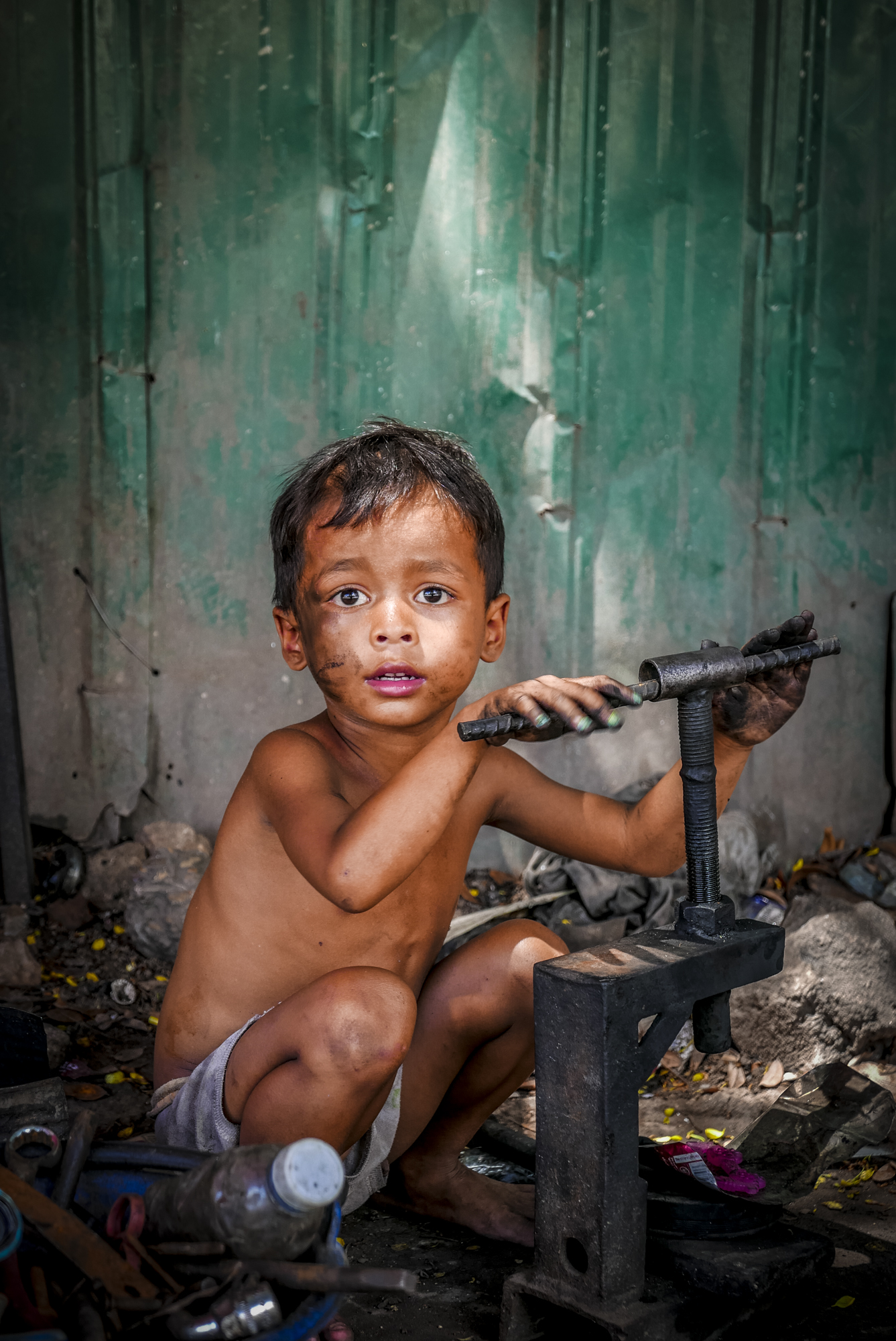 boy playing in the dirt in Phnom Penh in Cambodia