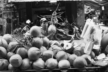 Coconut seller in the streets of Phnom Penh during a photo tour