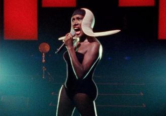 Grace Jones in white futuristic hat.