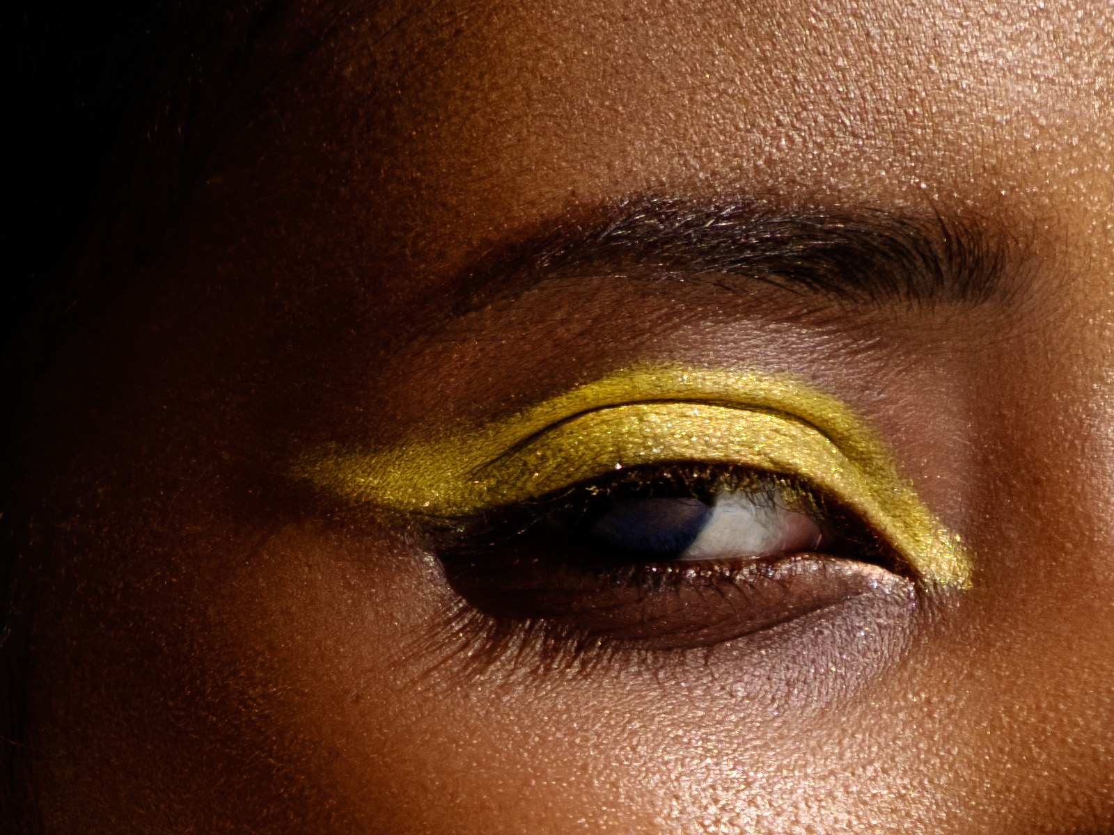 beauty close-up of black model with yellow eye shadow
