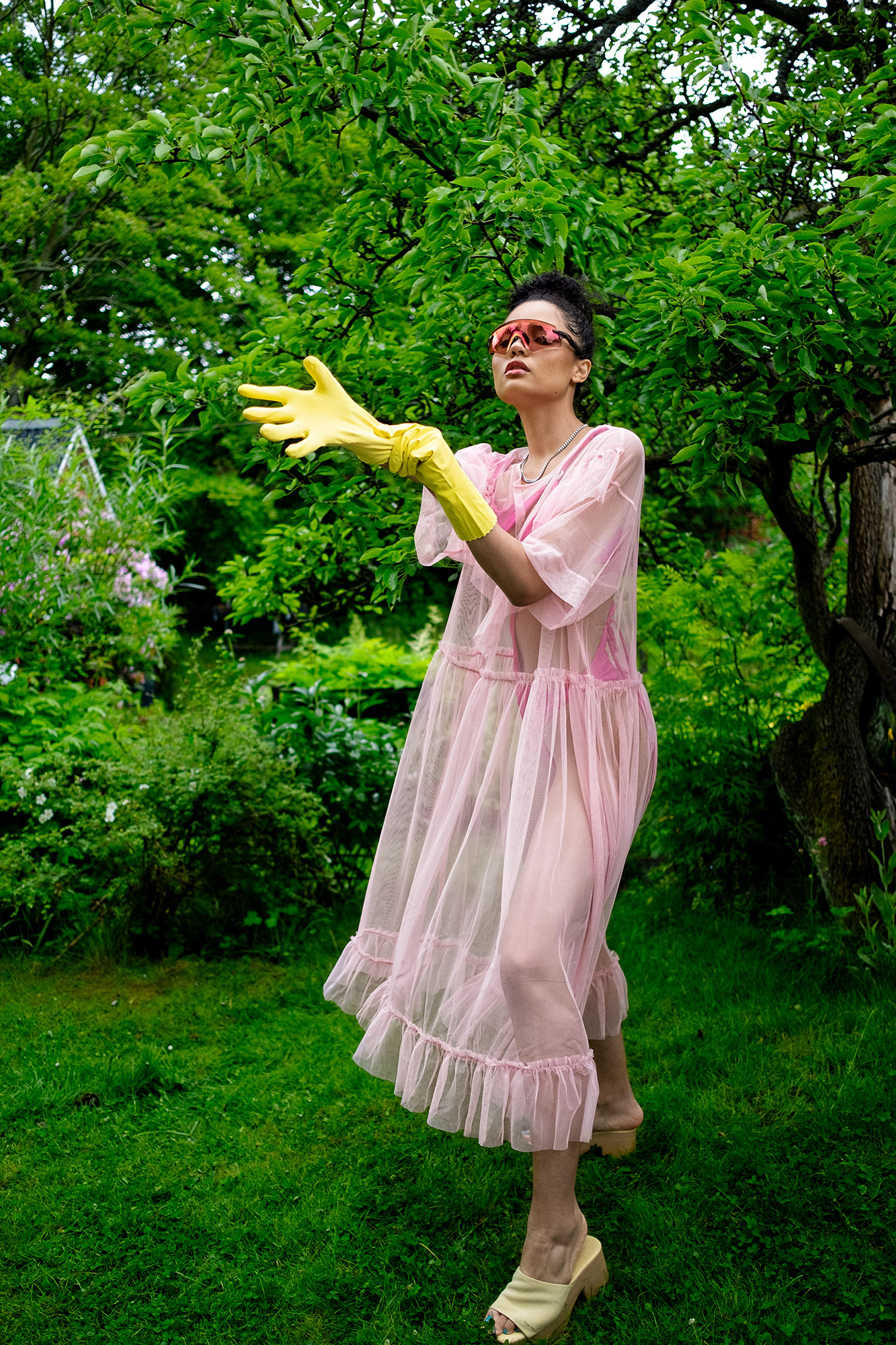 Krull magazine, Gardening Party fashion story, model in garden pink tulle dress over fuschia swimsuit