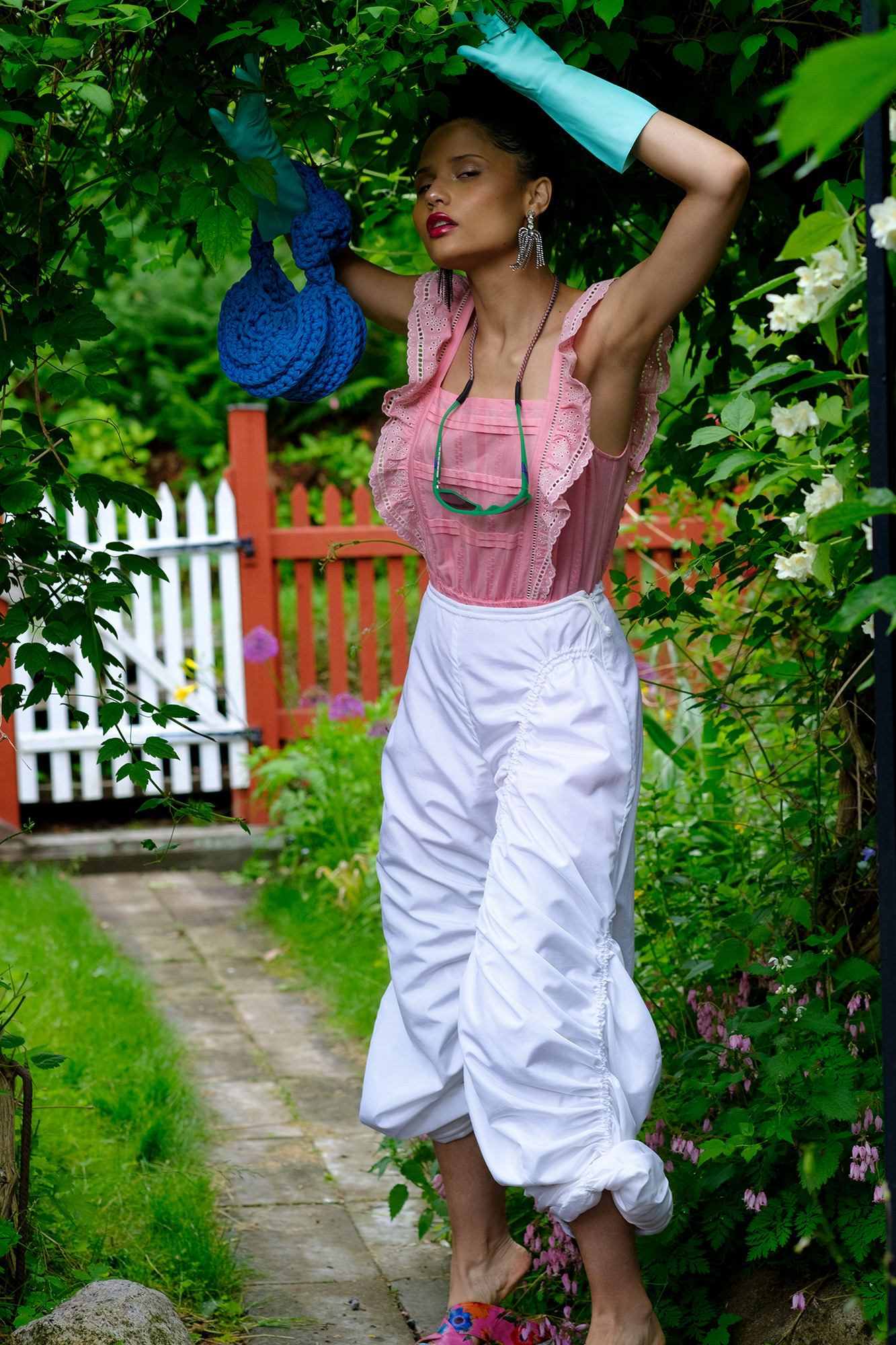 Krull magazine, Gardening Party fashion story. Model in lush green garden.